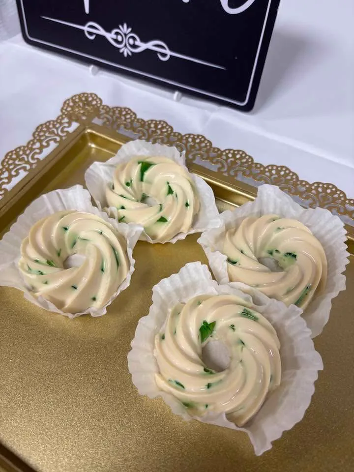 Before: four ring-shaped desserts on a gold tray with mixed background clutter