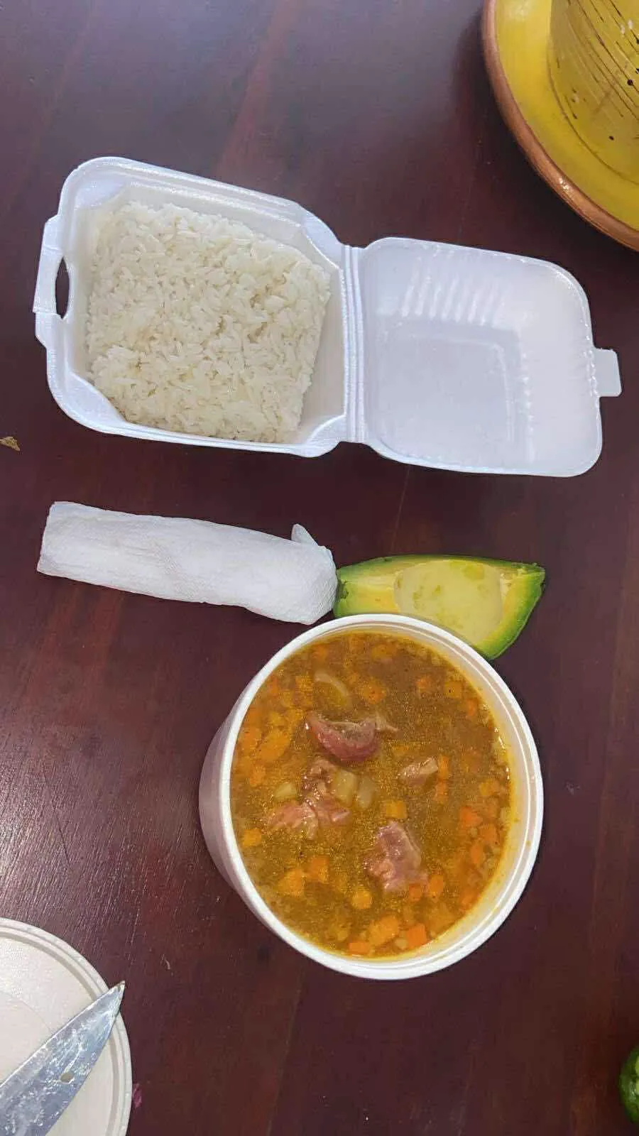Before: soup, rice, and avocado in takeout containers on dark wood table